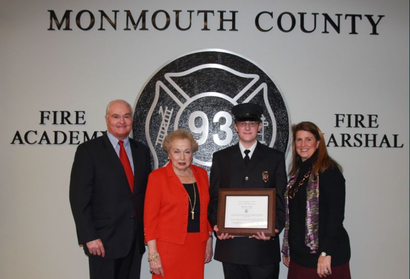 Freeholder John P. Curley, Freeholder Director Lillian G. Burry and Freeholder Serena DiMaso congratulate Evan D. Tyler of the Shrewsbury Hose Company, who was the recipient of the Class 100 Ronald Fitzpatrick Award.